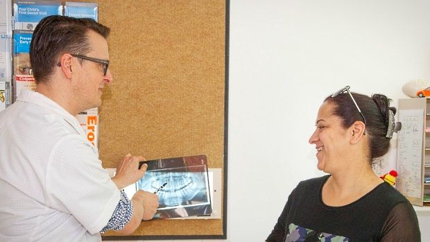 Photo of a dentist and a patient viewing an OPG X-Ray
