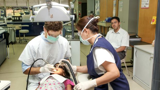 Photo of Two clinicians with patient and parent